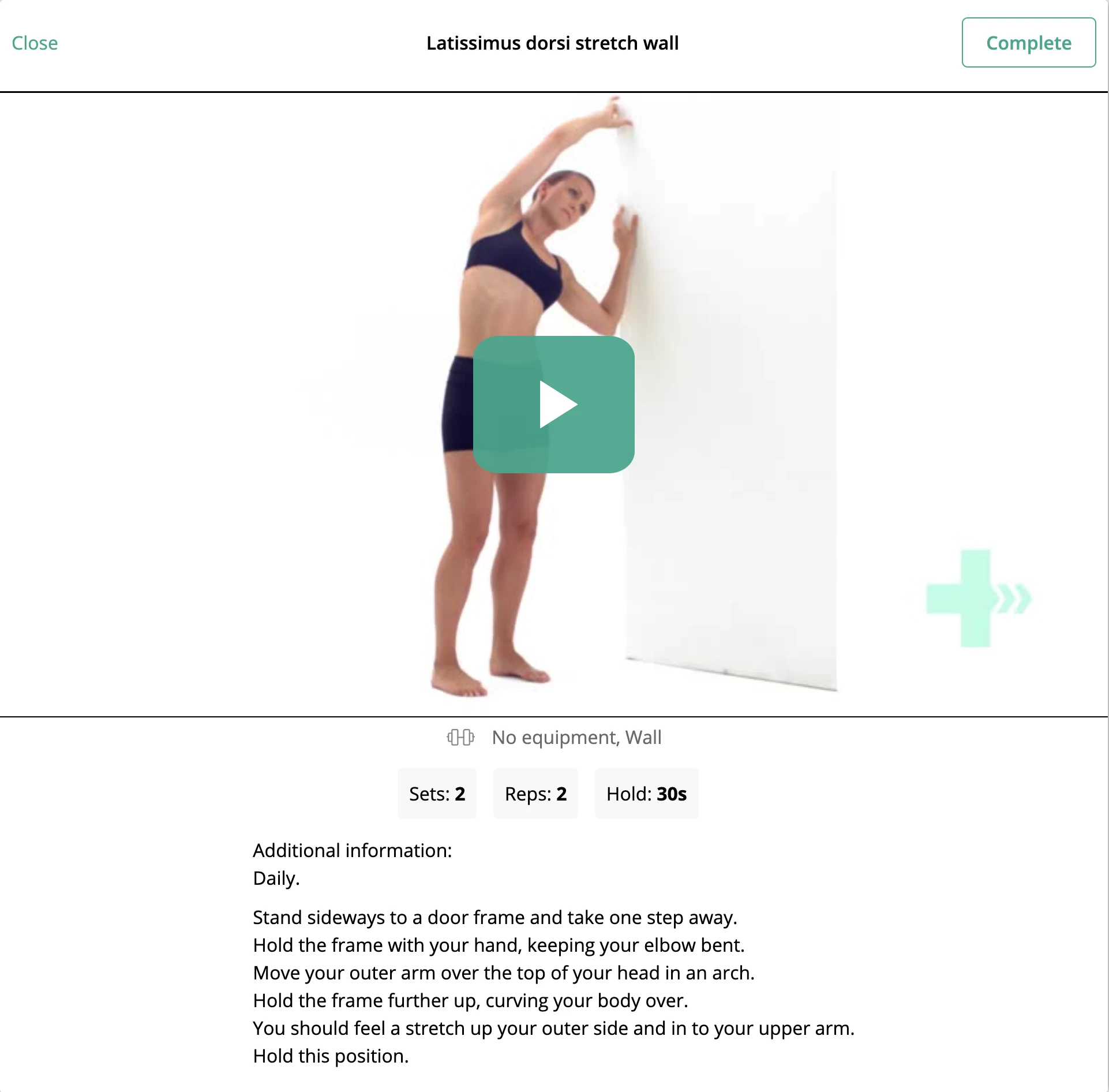 Latissimus dorsi stretch wall video screen showing exercise playback, sets, reps, equipment, and written instructions